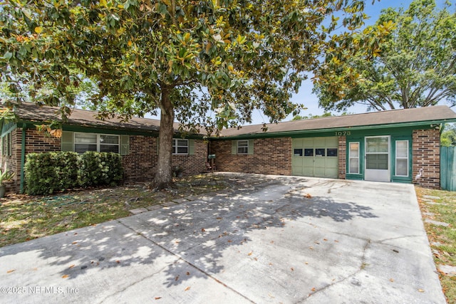 1073 Grove Park Ln, Orange Park, FL 32073 - single story home featuring brick siding, a garage, and driveway