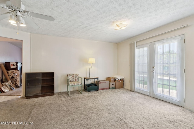 1073 Grove Park Ln, Orange Park, FL 32073 - living area featuring french doors, ceiling fan, a textured ceiling, and carpet flooring