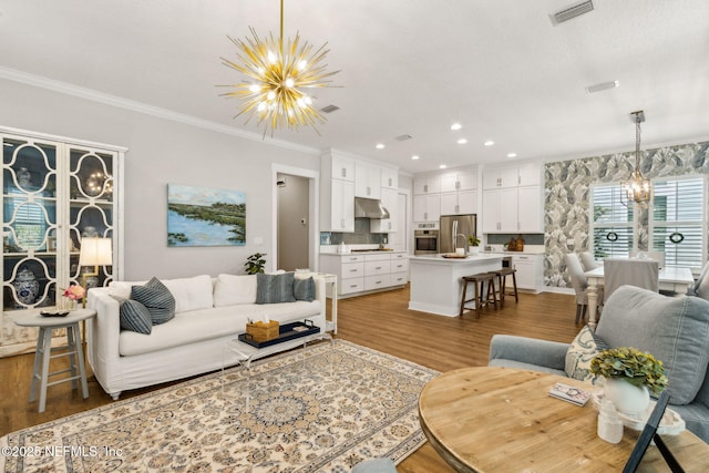 1787 Azalea St, Fernandina Beach, FL 32034 - living area with a chandelier, wood finished floors, crown molding, and recessed lighting