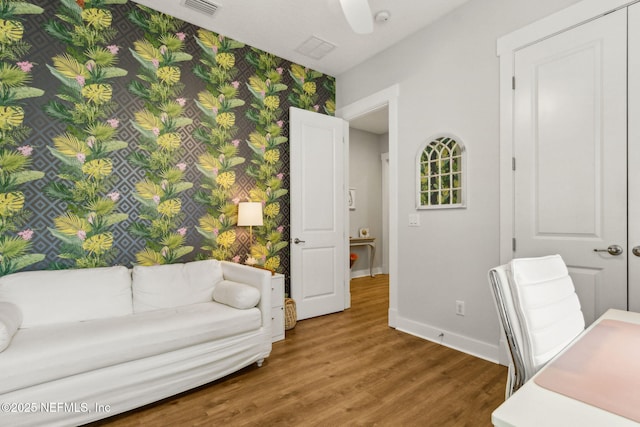 1787 Azalea St, Fernandina Beach, FL 32034 - home office with wallpapered walls, baseboards, wood finished floors, and an accent wall