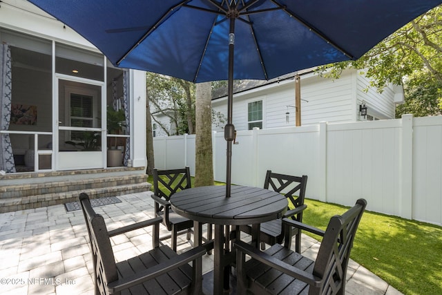 1787 Azalea St, Fernandina Beach, FL 32034 - wooden terrace featuring a sunroom, outdoor dining space, and a patio