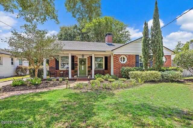 4371 Gadsden Ct, Jacksonville, FL 32207 - ranch-style home with a chimney, a front lawn, brick siding, and a porch