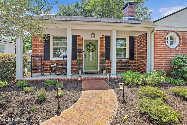 4371 Gadsden Ct, Jacksonville, FL 32207 - view of front facade featuring covered porch, brick siding, and a chimney