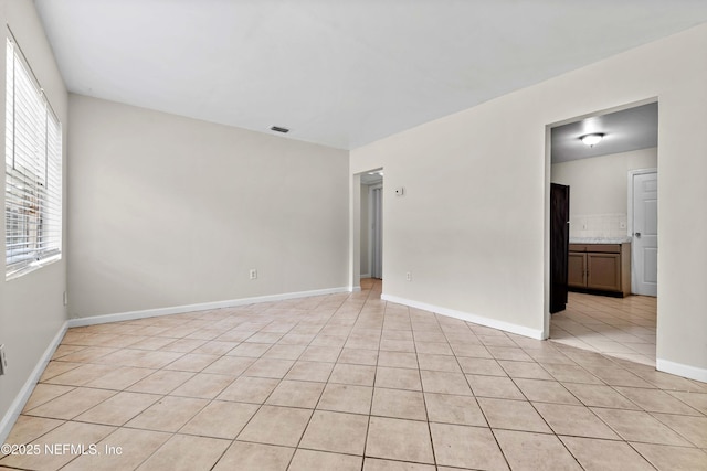 602 Luna Ct, Jacksonville, FL 32205 - spare room with light tile patterned floors and baseboards