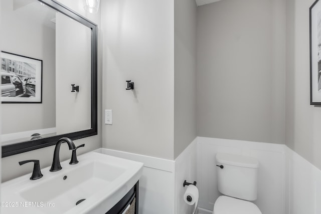 287 Richmond Dr, Saint Johns, FL 32259 - half bathroom with toilet, vanity, and wainscoting