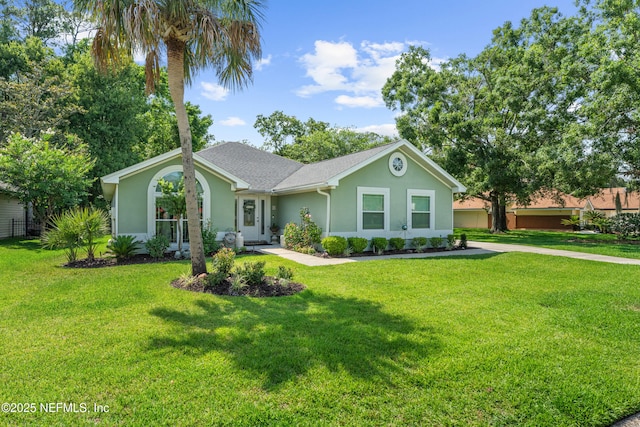 1500 Marsh Rabbit Way, Fleming Island, FL 32003 - single story home with stucco siding, a front yard, and a shingled roof