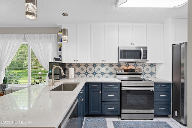 1500 Marsh Rabbit Way, Fleming Island, FL 32003 - kitchen featuring appliances with stainless steel finishes, a sink, white cabinets, light tile patterned floors, and open shelves