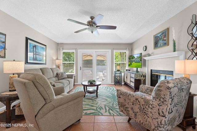 1500 Marsh Rabbit Way, Fleming Island, FL 32003 - living area featuring a fireplace, ceiling fan, and a textured ceiling
