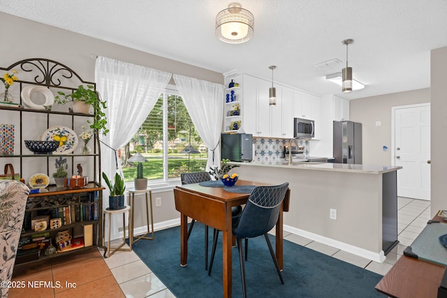 1500 Marsh Rabbit Way, Fleming Island, FL 32003 - dining room featuring light tile patterned floors and a textured ceiling