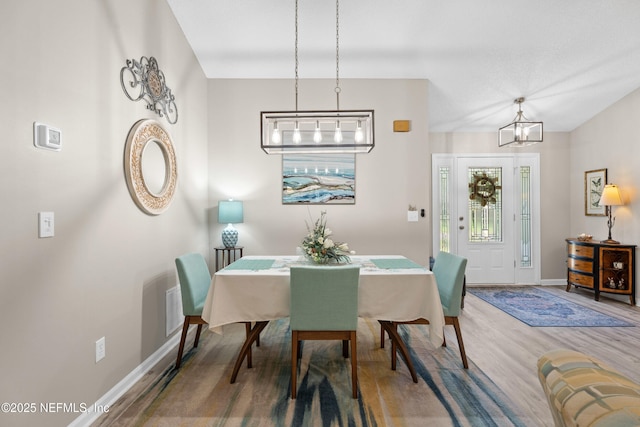 1500 Marsh Rabbit Way, Fleming Island, FL 32003 - dining room with baseboards, wood finished floors, and a chandelier
