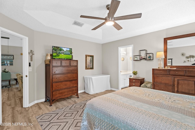 1500 Marsh Rabbit Way, Fleming Island, FL 32003 - bedroom featuring light wood-style flooring, baseboards, a textured ceiling, ensuite bathroom, and a ceiling fan