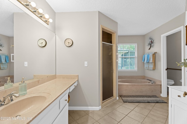 1500 Marsh Rabbit Way, Fleming Island, FL 32003 - full bathroom with vanity, a textured ceiling, a garden tub, tile patterned floors, and toilet