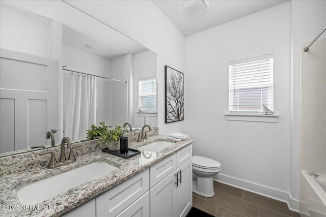 5801 SE County Road 21b, Keystone Heights, FL 32656 - full bathroom featuring double vanity, toilet, shower / bathtub combination with curtain, baseboards, and wood tiled floors