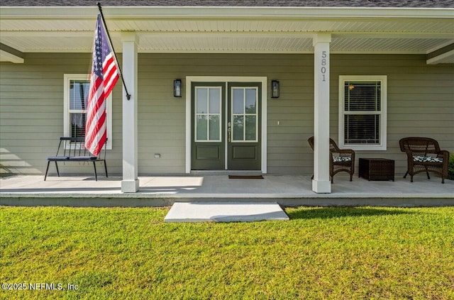 5801 SE County Road 21b, Keystone Heights, FL 32656 - doorway to property featuring covered porch and a yard