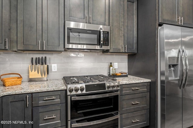 5801 SE County Road 21b, Keystone Heights, FL 32656 - kitchen featuring appliances with stainless steel finishes, tasteful backsplash, and light stone countertops