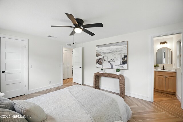 1233 Boca Grande Ave, Jacksonville, FL 32233 - bedroom with baseboards, a sink, ensuite bath, and ceiling fan