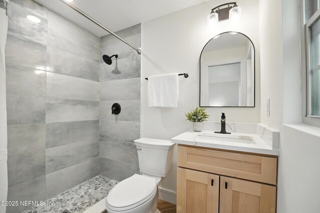 1233 Boca Grande Ave, Jacksonville, FL 32233 - full bathroom featuring toilet, a tile shower, and vanity