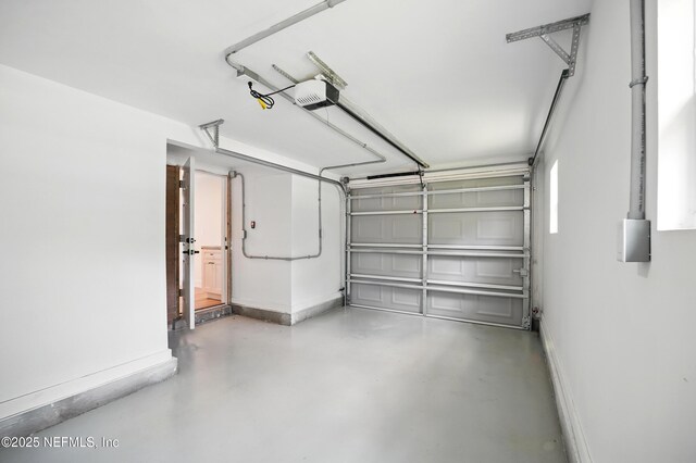 1233 Boca Grande Ave, Jacksonville, FL 32233 - garage featuring a garage door opener and baseboards