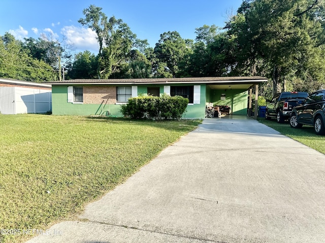 6316 Pine Summit Dr, Jacksonville, FL 32211 - view of front facade featuring concrete driveway, a front yard, concrete block siding, and an attached carport