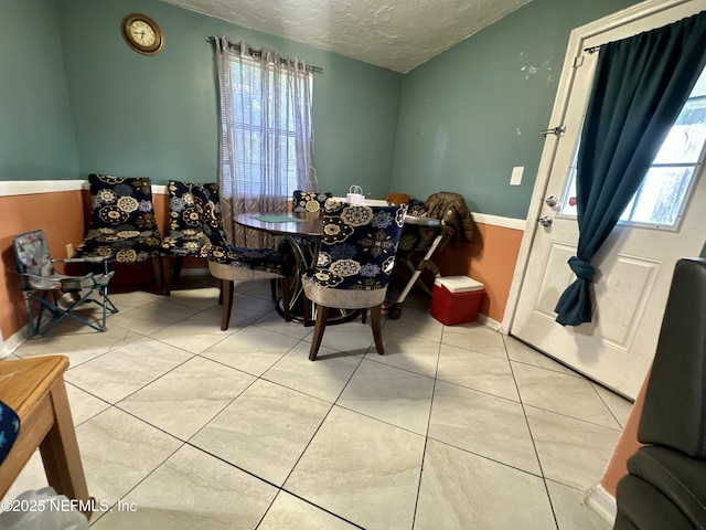 6316 Pine Summit Dr, Jacksonville, FL 32211 - tiled dining space featuring a textured ceiling and baseboards