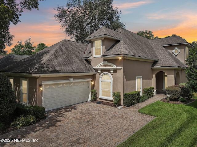 4640 Tuscan Wood Ct, Saint Augustine, FL 32092 - view of front facade with stucco siding, an attached garage, decorative driveway, and roof with shingles