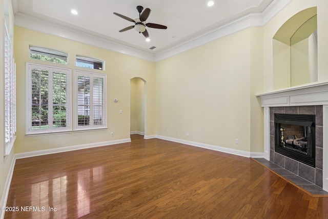 4640 Tuscan Wood Ct, Saint Augustine, FL 32092 - unfurnished living room with ceiling fan, crown molding, wood finished floors, a fireplace, and arched walkways