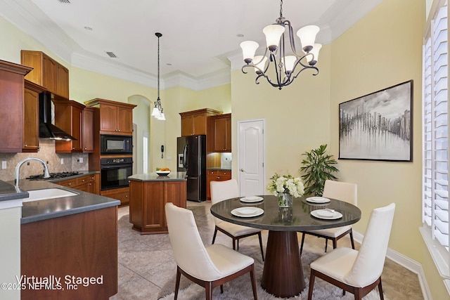 4640 Tuscan Wood Ct, Saint Augustine, FL 32092 - dining room featuring a chandelier, light tile patterned floors, crown molding, arched walkways, and a high ceiling