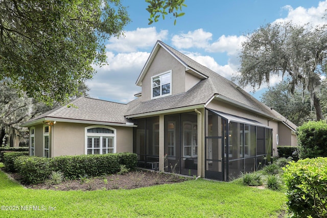 4640 Tuscan Wood Ct, Saint Augustine, FL 32092 - rear view of house with stucco siding, a sunroom, roof with shingles, and a lawn
