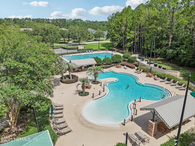 4640 Tuscan Wood Ct, Saint Augustine, FL 32092 - community pool with a patio and view of wooded area