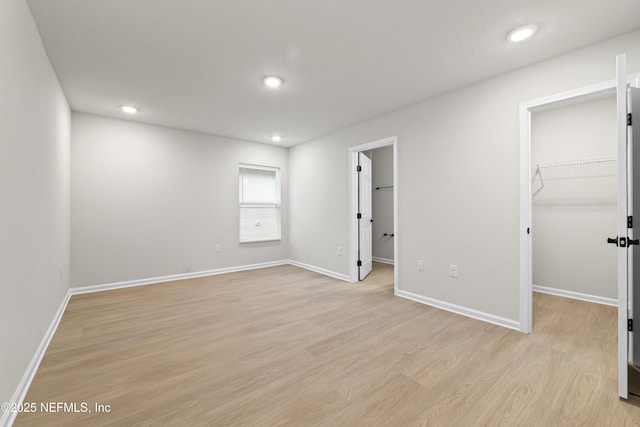 5969 Flicker Ave, Jacksonville, FL 32219 - unfurnished bedroom featuring a walk in closet, light wood-type flooring, recessed lighting, baseboards, and a closet
