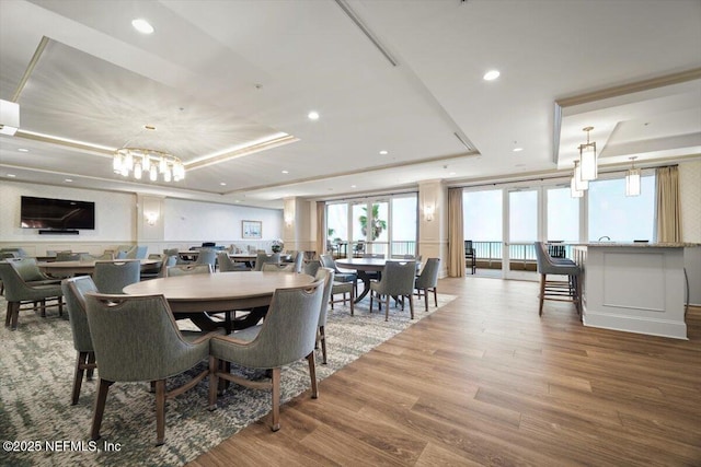 1031 1st St S Unit 1202, Jacksonville Beach, FL 32250 - dining room featuring a raised ceiling, wood finished floors, recessed lighting, and a chandelier