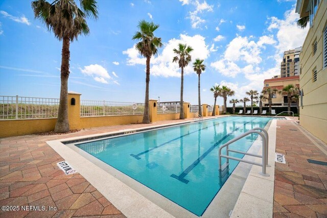 1031 1st St S Unit 1202, Jacksonville Beach, FL 32250 - community pool with a patio area