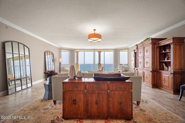 1031 1st St S Unit 1202, Jacksonville Beach, FL 32250 - kitchen with ornamental molding, open floor plan, a textured ceiling, baseboards, and light tile patterned flooring