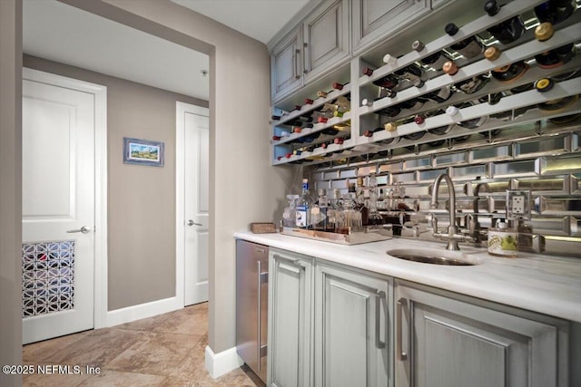 1031 1st St S Unit 1202, Jacksonville Beach, FL 32250 - indoor wet bar featuring beverage cooler, baseboards, and tasteful backsplash