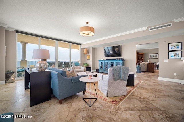 1031 1st St S Unit 1202, Jacksonville Beach, FL 32250 - living area with crown molding, baseboards, expansive windows, and a textured ceiling