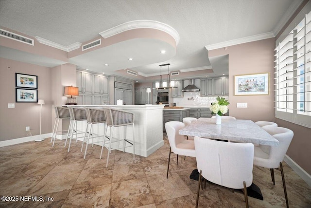 1031 1st St S Unit 1202, Jacksonville Beach, FL 32250 - dining area featuring crown molding, a textured ceiling, and baseboards