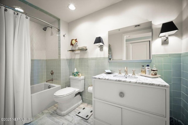 1031 1st St S Unit 1202, Jacksonville Beach, FL 32250 - bathroom featuring tile walls, shower / tub combo, vanity, toilet, and a wainscoted wall