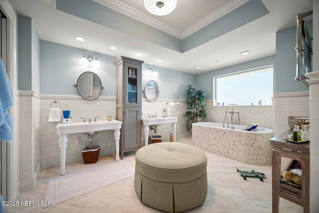 1031 1st St S Unit 1202, Jacksonville Beach, FL 32250 - bathroom featuring tile walls, crown molding, a bath, a wainscoted wall, and recessed lighting