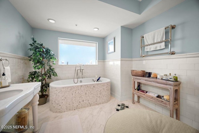 1031 1st St S Unit 1202, Jacksonville Beach, FL 32250 - full bathroom with tile walls, wainscoting, a garden tub, and marble finish floors