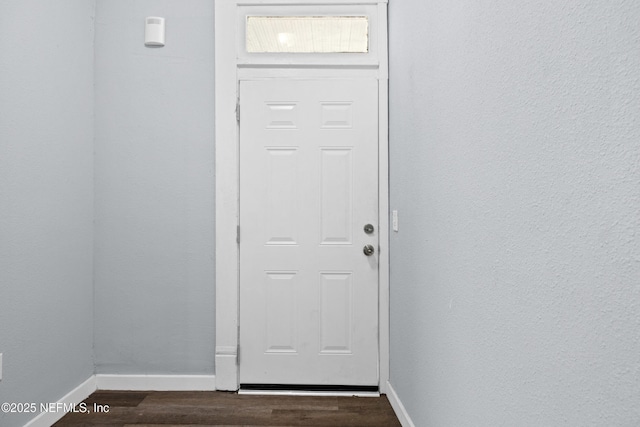 209 E 17th St, Jacksonville, FL 32206 - doorway with dark wood-style flooring and baseboards