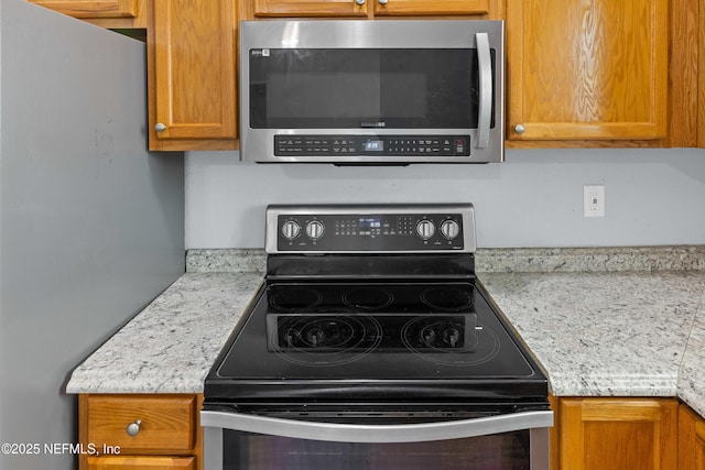 209 E 17th St, Jacksonville, FL 32206 - kitchen featuring stainless steel appliances, light countertops, and brown cabinets