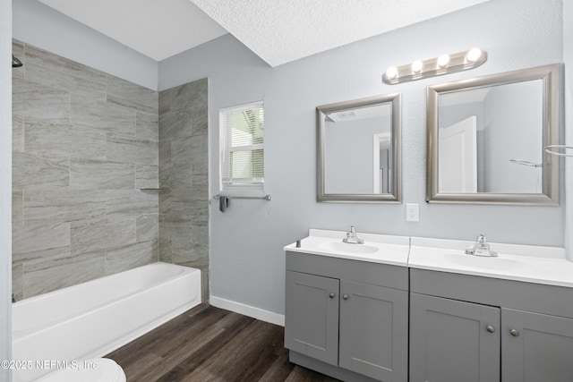 209 E 17th St, Jacksonville, FL 32206 - bathroom with wood finished floors, baseboards, double vanity, and shower / bath combination