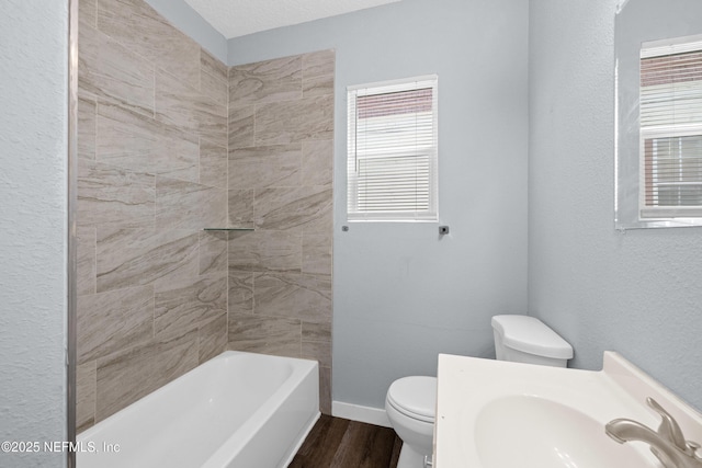 209 E 17th St, Jacksonville, FL 32206 - bathroom with toilet, wood finished floors, baseboards, tub / shower combination, and vanity