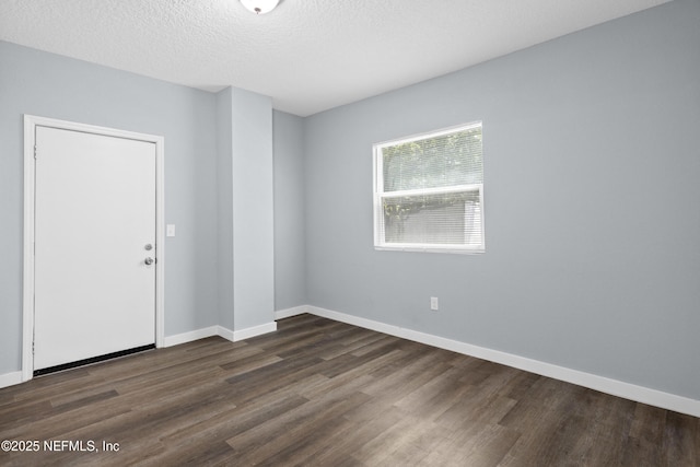 209 E 17th St, Jacksonville, FL 32206 - empty room with dark wood-type flooring, baseboards, and a textured ceiling