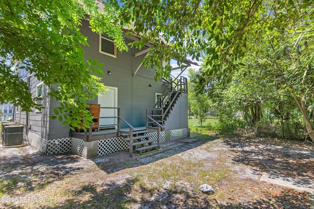 209 E 17th St, Jacksonville, FL 32206 - back of property featuring cooling unit, a wooden deck, and stairway