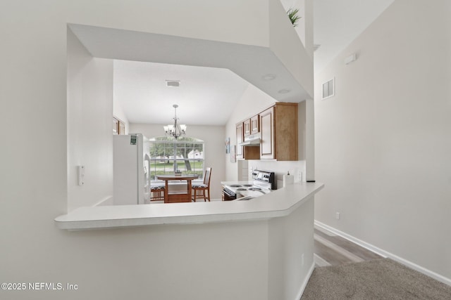 1260 Winding Brook Ct, Middleburg, FL 32068 - kitchen with white appliances, a chandelier, light countertops, and brown cabinetry