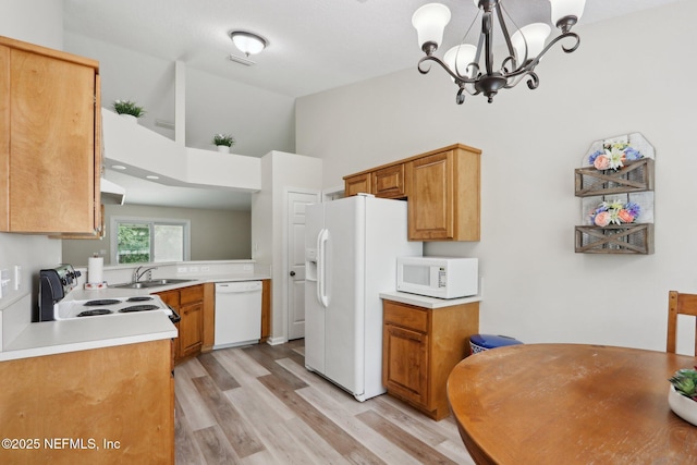 1260 Winding Brook Ct, Middleburg, FL 32068 - kitchen featuring white appliances, a sink, a chandelier, light wood-type flooring, and light countertops