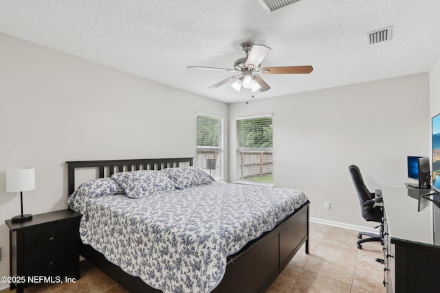 1260 Winding Brook Ct, Middleburg, FL 32068 - bedroom featuring a desk, light tile patterned flooring, ceiling fan, baseboards, and a textured ceiling