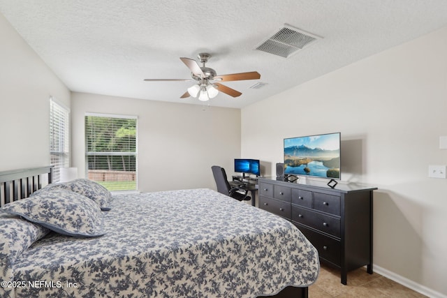 1260 Winding Brook Ct, Middleburg, FL 32068 - bedroom with light tile patterned floors, baseboards, ceiling fan, and a textured ceiling
