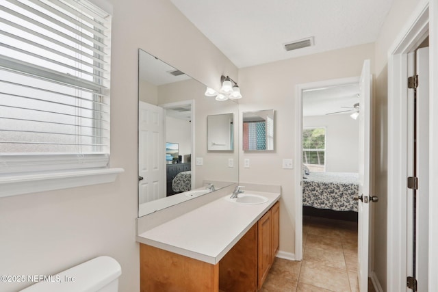 1260 Winding Brook Ct, Middleburg, FL 32068 - ensuite bathroom featuring vanity, toilet, tile patterned flooring, and a ceiling fan
